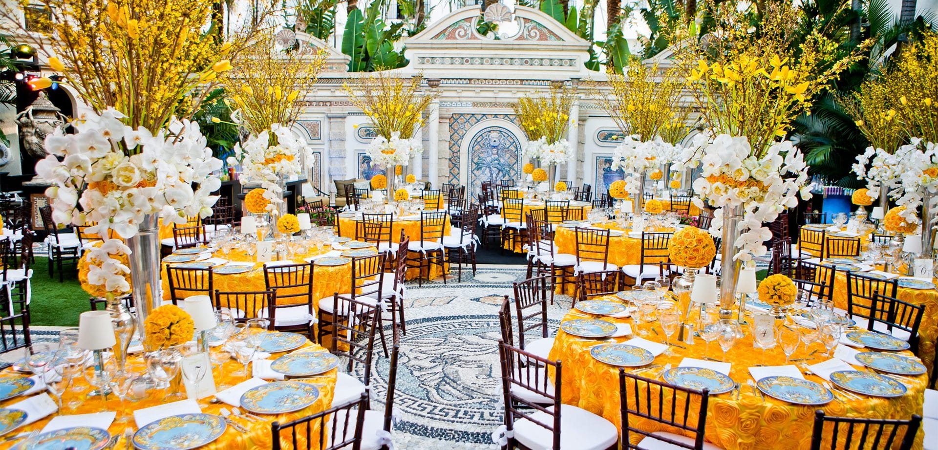 A dinner setup with an orange and white color scheme